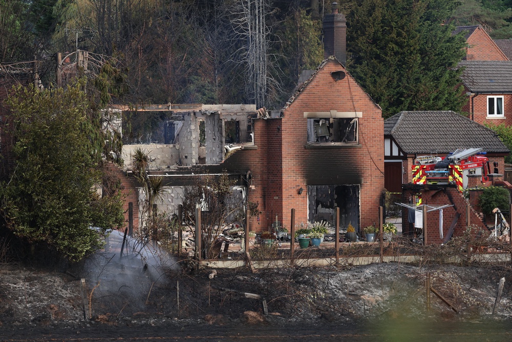 Firefighters work at the site of a fire-damaged house in Stourbridge, south-west of Birmingham (AFP/Getty)