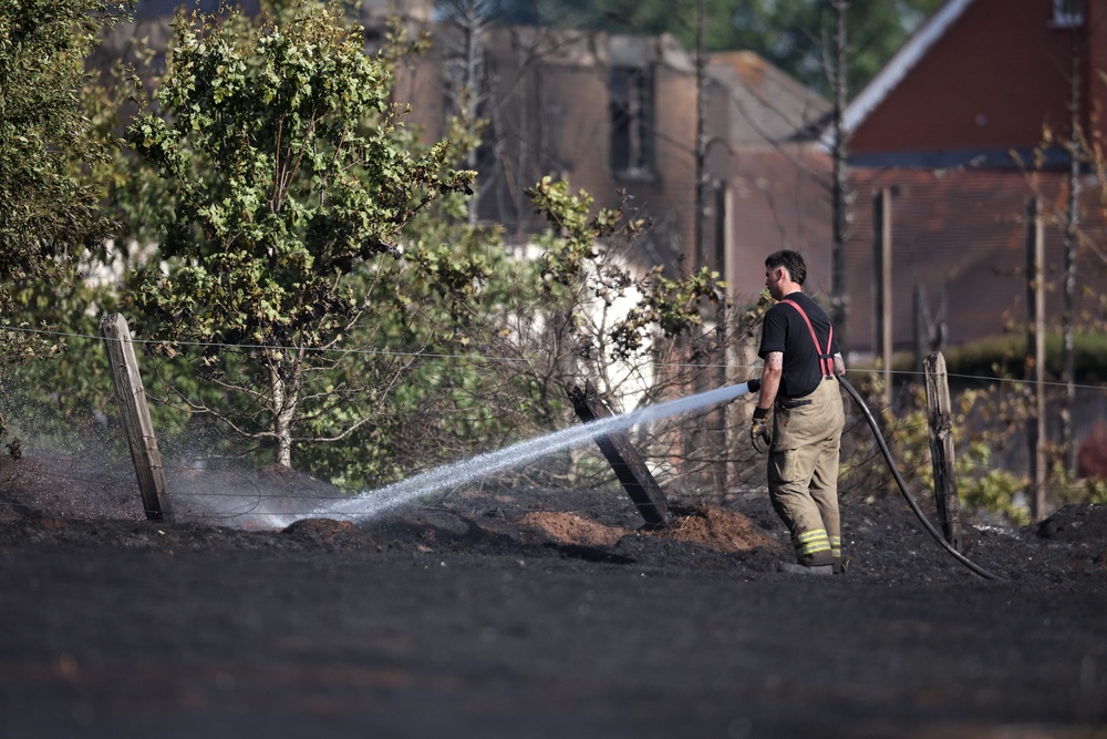 There have been several wildfires this summer, including in the West Midlands. Here, emergency services attend the scene near the burnt out remains of homes following a huge fire in Stourbridge (Getty)