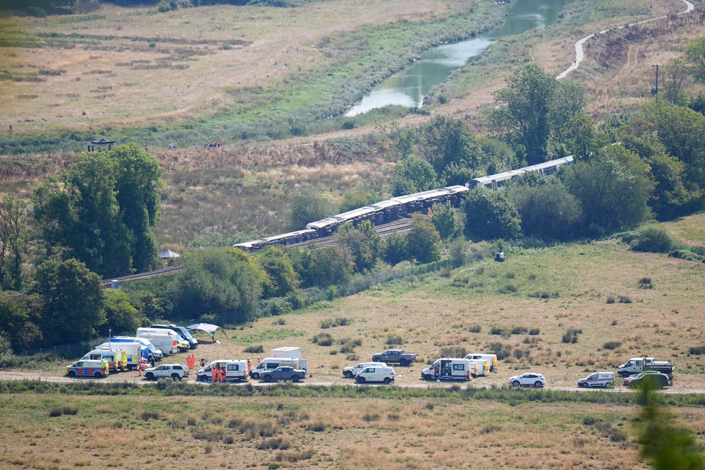 Emergency services at the scene after a train with around 150 people on board derailed (PA)