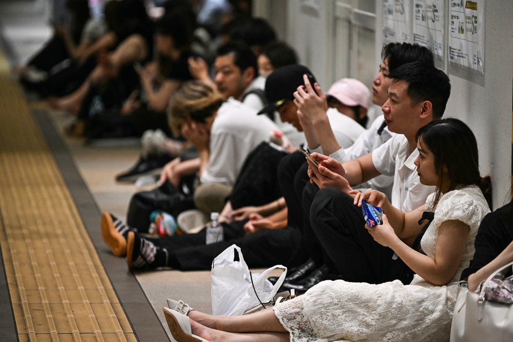 Stranded passengers sit on the floor at Chiba Metro Station in Chiba (AFP/Getty)