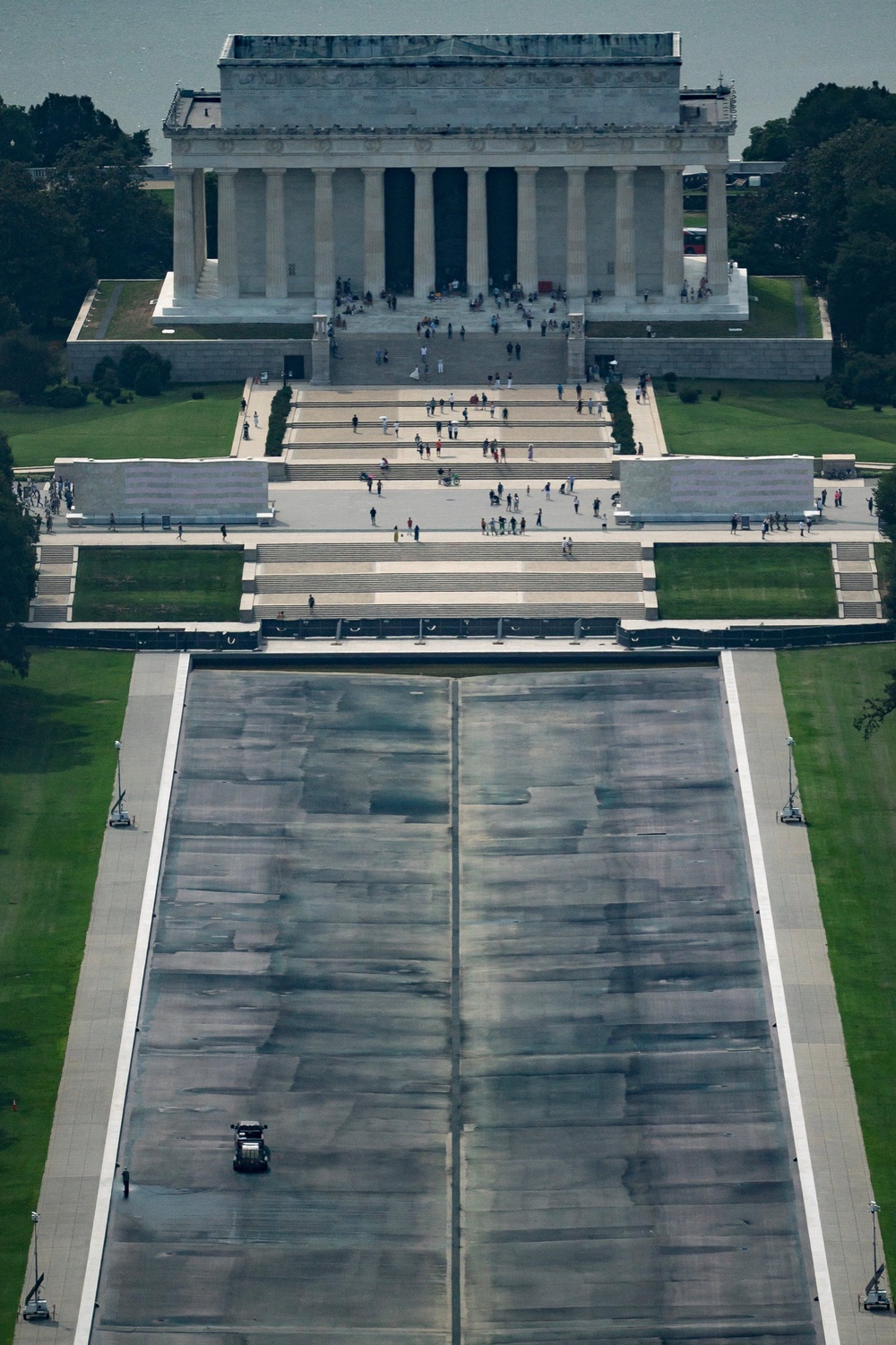 Construction crews continue work on the Lincoln Memorial Reflecting Pool on Thursday after it was once again drained for repairs stemming from what President Donald Trump has called ‘vandalism’ but ... (Reuters)
