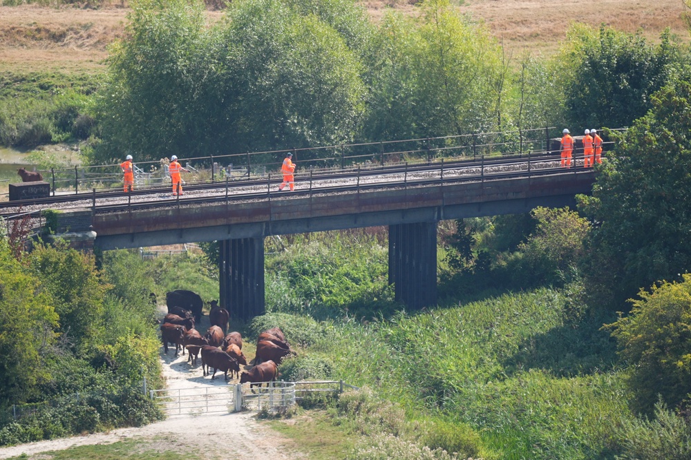 Rail company workers walk along the tracks on Friday (James Manning/PA) (PA Wire)