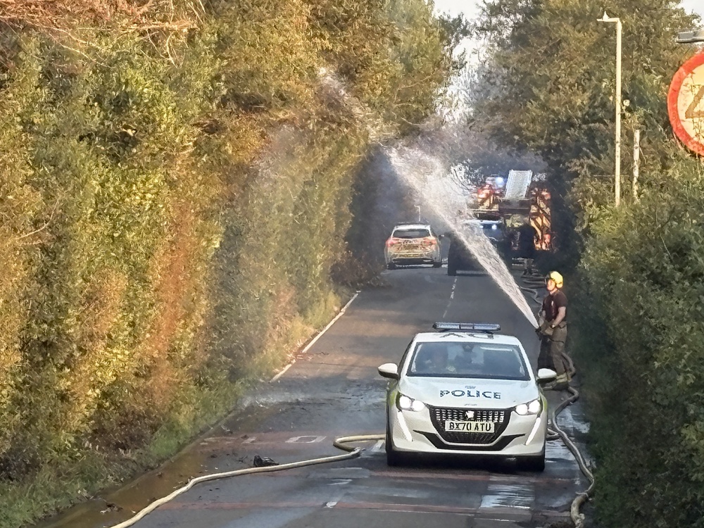 Fire crews working on Racecourse Lane, Stourbridge, near properties damaged by a major fire (Matthew Cooper/PA) (PA Wire)