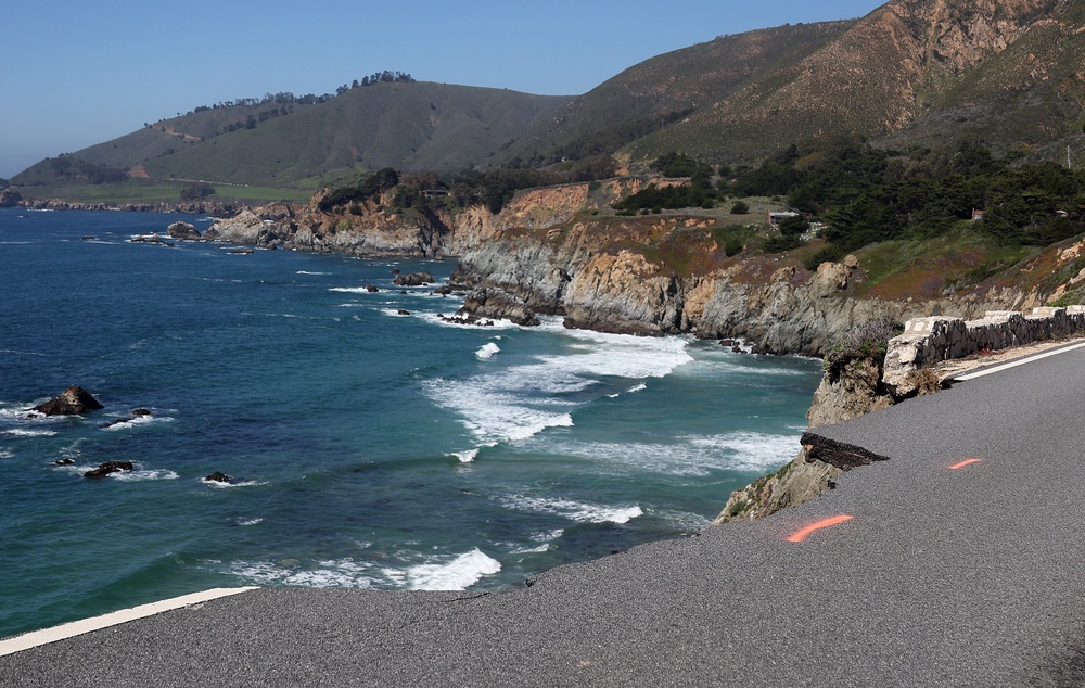 A hole is visible where a section of southbound Highway 1 broke off and fell in the ocean at Rocky Creek Bridge in 2024 following heavy rains, part of the destruction that spurred the revamp of the fabled higheway stretch (Getty Images)