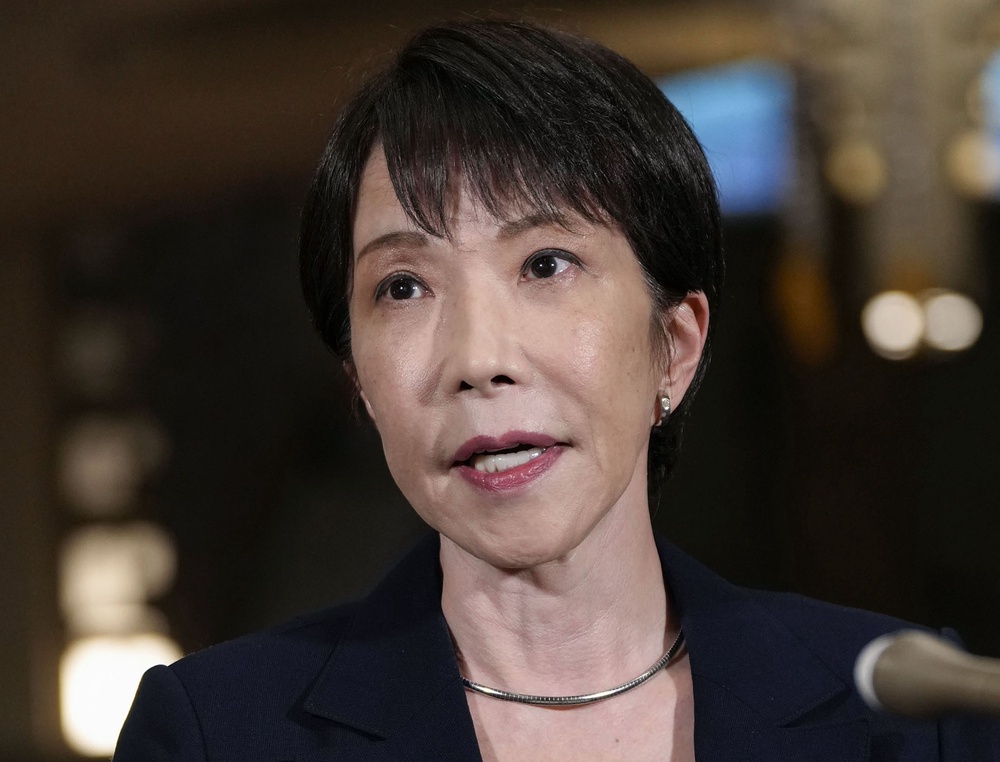 Sanae Takaichi speaks to journalists after Russian president Vladimir Putin’s visit to the Kuril islands (AP)