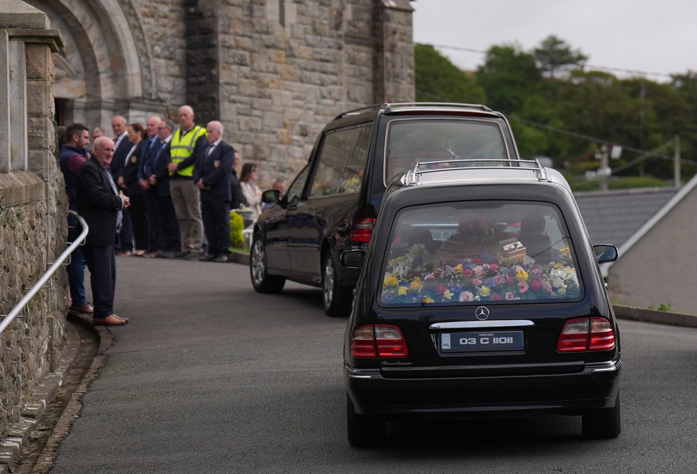 Hearses carrying the coffins of James and Noreen McHugh arrive at St. Cartha’s Church (Niall Carson/PA) (PA Wire)