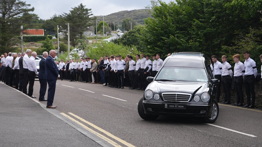 Past and present members of the Co Donegal All Ireland Gaelic Football teams hold a Guard of Honour (Niall Carson/PA) (PA Wire)