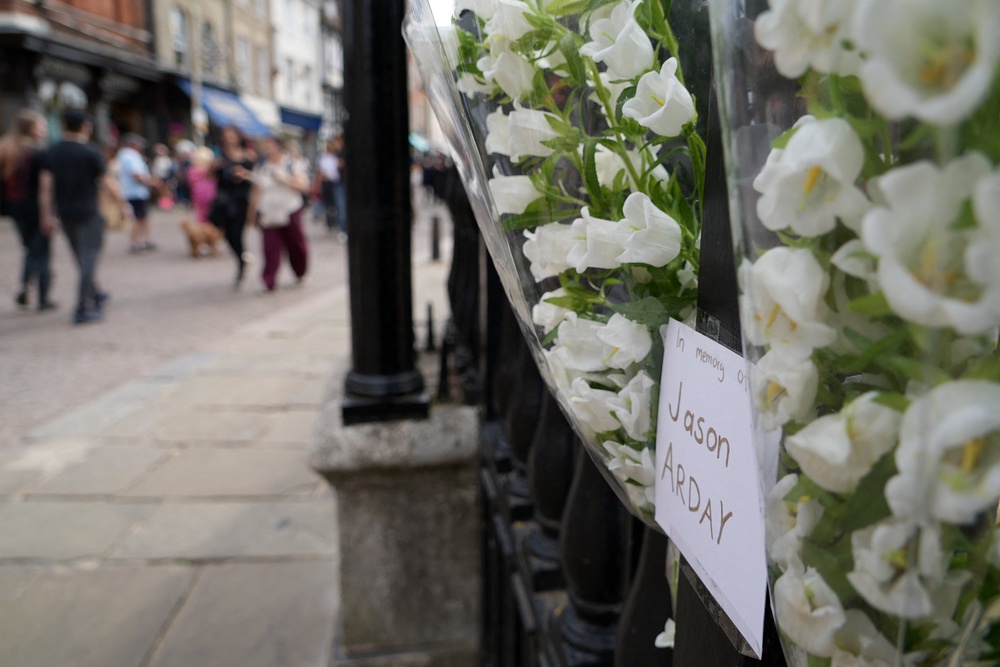 Floral tributes to remember academic Jason Arday, attached to the railings outside Senate House in the University of Cambridge (AFP/Getty)