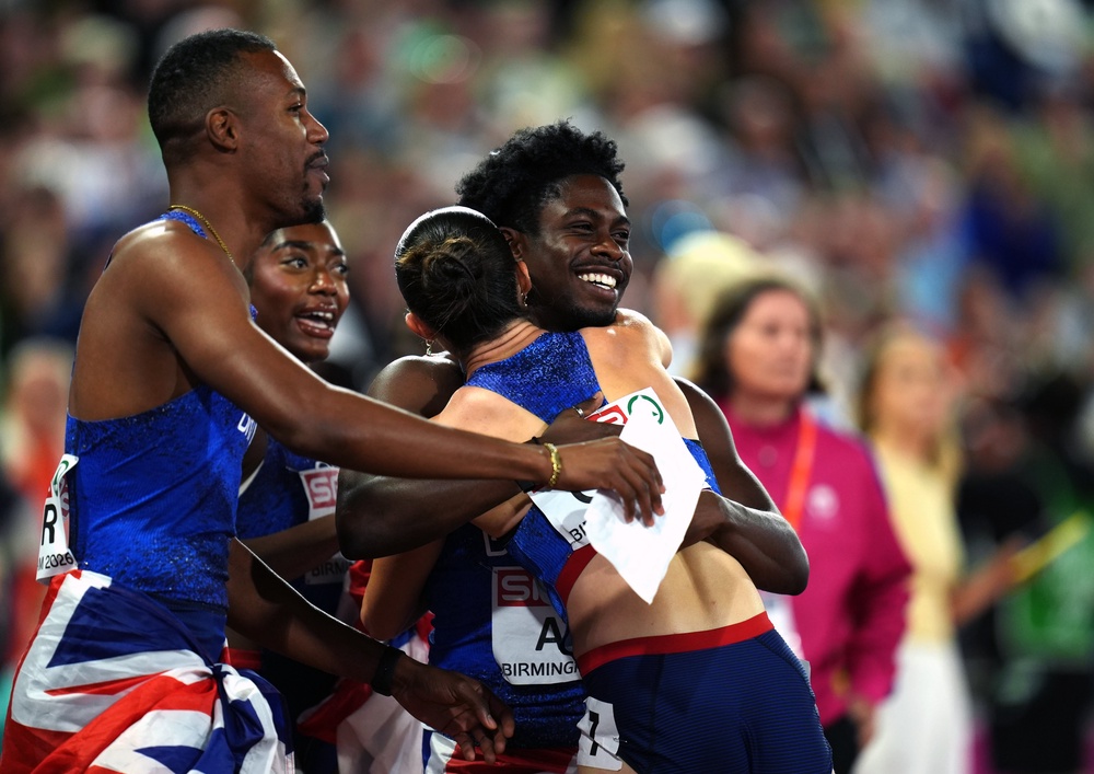 Jeremiah Azu, right, hugs Amy Hunt as they celebrate their relay gold medals (Annabel Lee-Ellis/PA) (PA Wire)