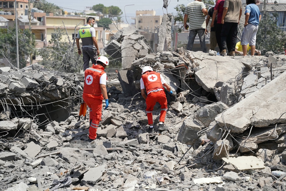 First aid responders and residents rush to the site of an Israeli airstrike in the southern Lebanese village of Deir al-Zahrani (AFP/Getty)