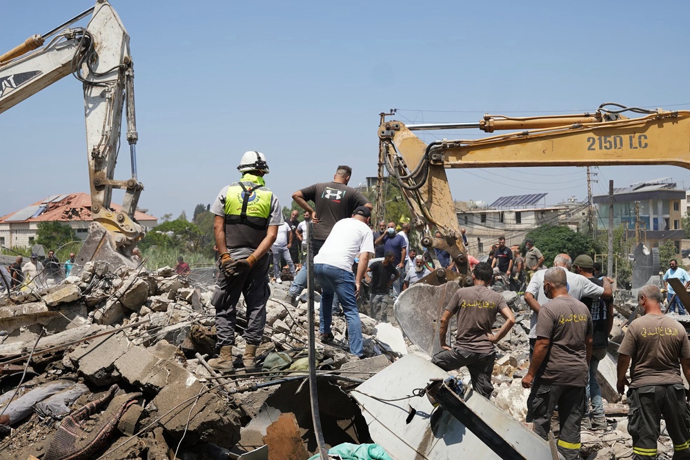 Heavy machinery, first aid responders and residents search the site of an Israeli airstrike in southern Lebanon (AFP/Getty)