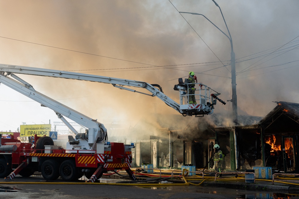 Ukrainian rescuers work at the site of a Russian strike in Kyiv (AFP/Getty)
