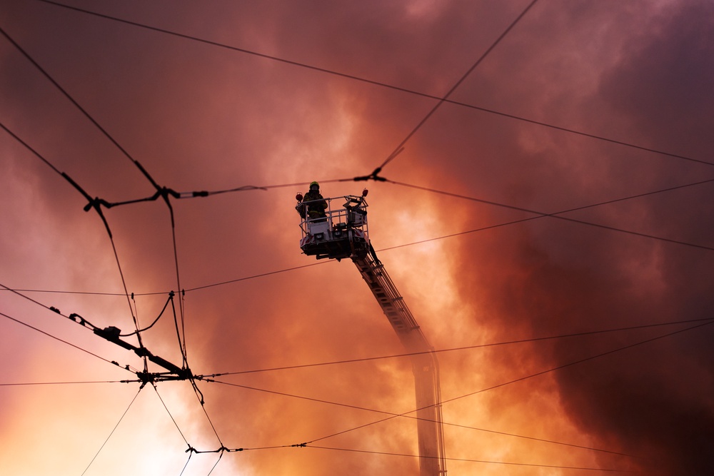 Firefighters try to put out a fire at a city book market following a Russian missile attack in Kyiv (AP)