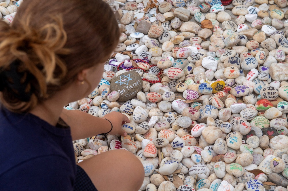 A visitor places a pebble at a memorial site at Bondi Beach (Reuters)