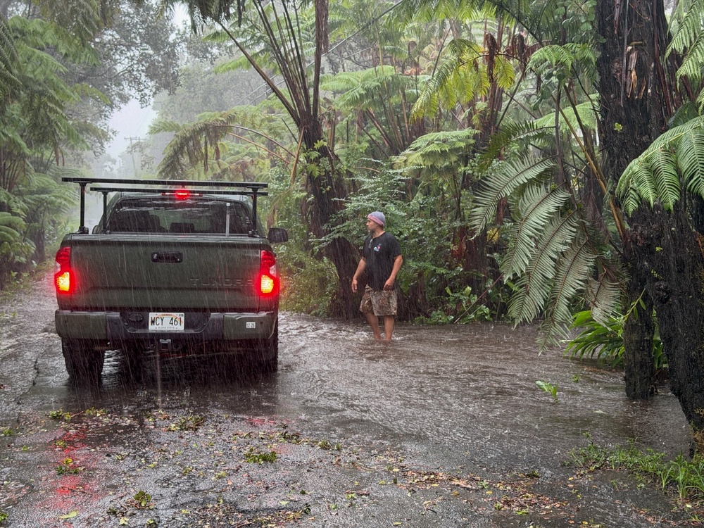 A resident stops on a rural road as it floods in Volcano Village on Hawaii Island (AFP/Getty)
