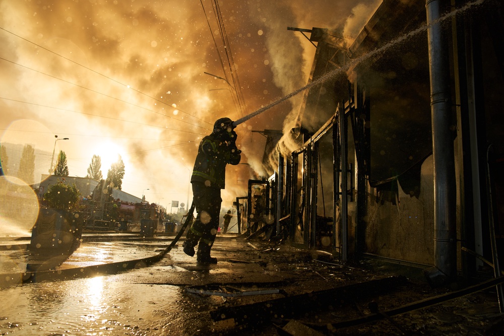Firefighters try to put out a fire at a city book market following a Russian missile attack in Kyiv (Copyright 2026 The Associated Press. All rights reserved)