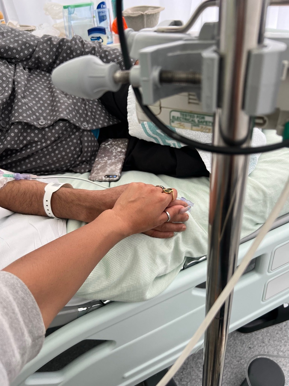 Zahida holding father’s hand in hospital bed (Collect/PA Real Life)