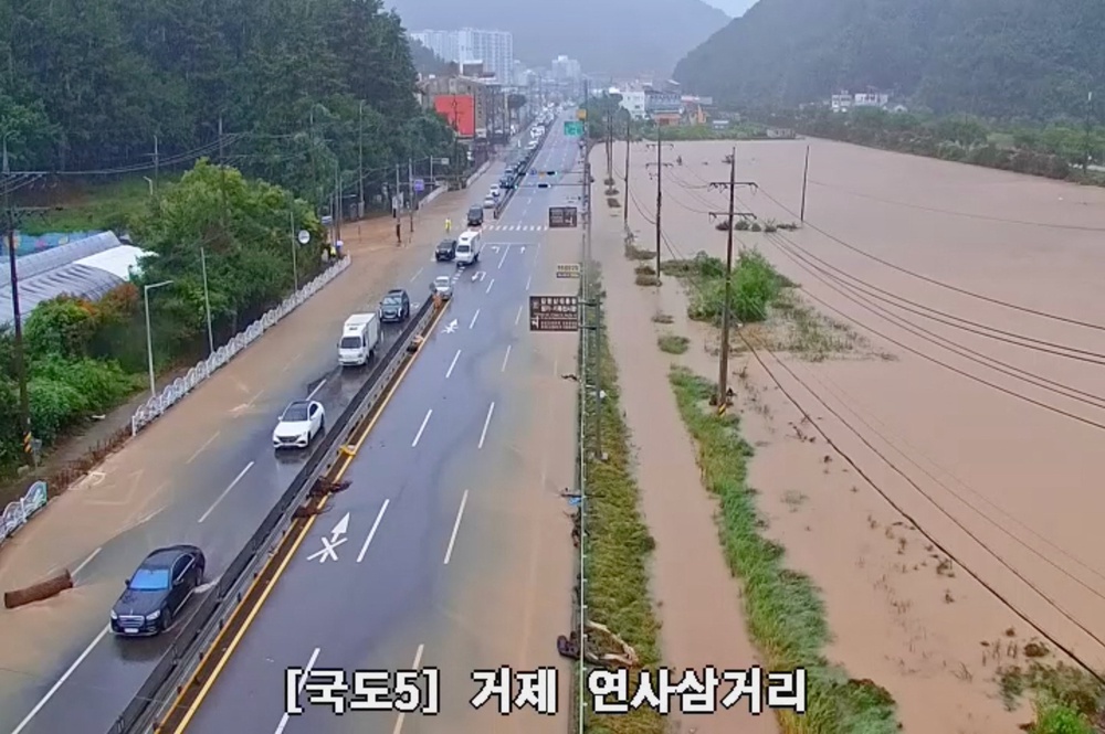 Vehicles navigate flooded road in South Korea's Geoje (Reuters)