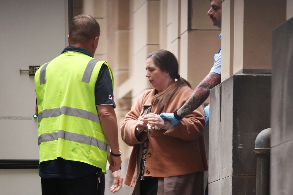 Convicted murderer Erin Patterson is escorted out of the Supreme Court of Victoria following the day's proceedings in a pre-sentencing hearing in Melbourne on 25 August 2025 (AFP/Getty)