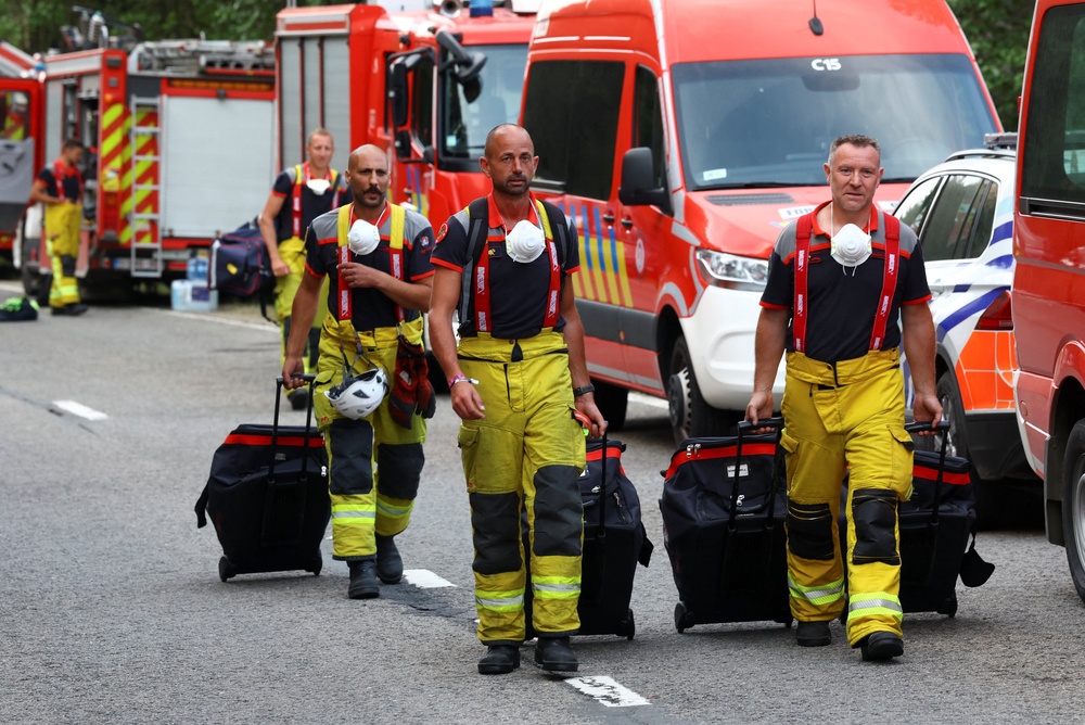 Firefighters arrive at a command post in Eupen, amid a wildfire in the High Fens (Hautes Fagnes) region, Belgium (Reuters)