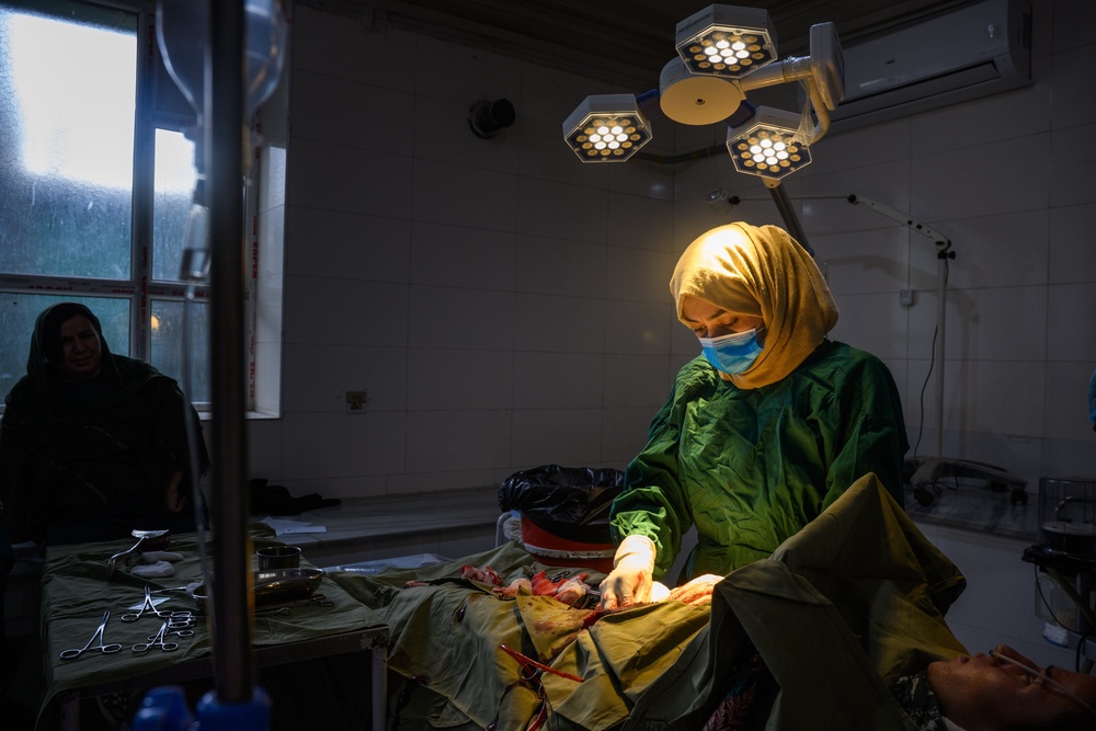 A medical doctor and surgeon completes a C-section after assisting another surgeon at the provincial hospital's maternity unit in Ghazni (Getty)