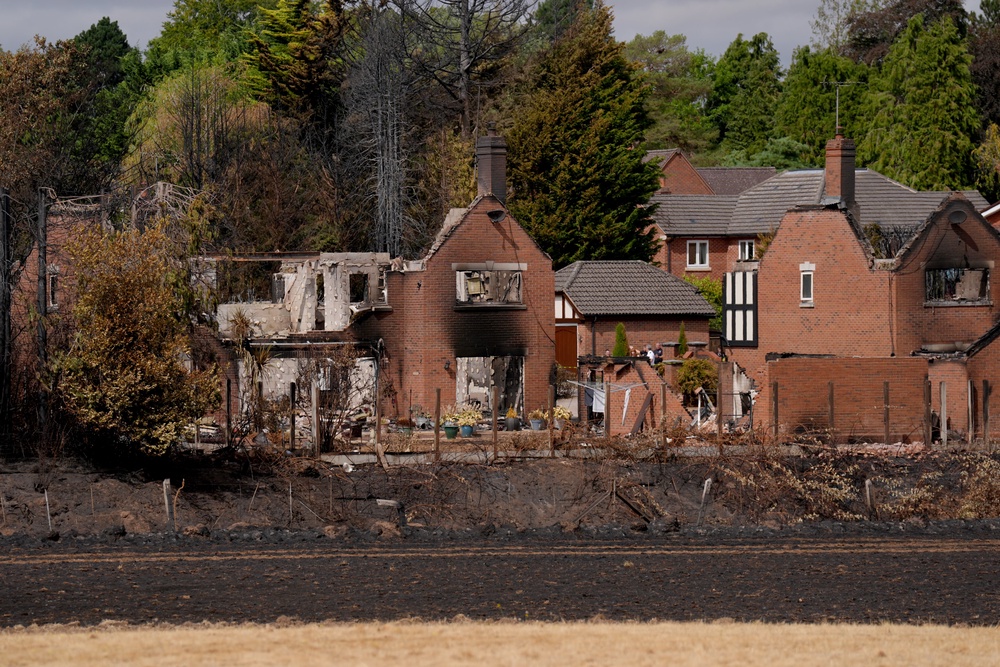 Housing Secretary Angela Rayner views the burnt-out remains of houses on Quarry Park Road in Stourbridge, West Midlands (Joe Giddens/PA) (PA Wire)