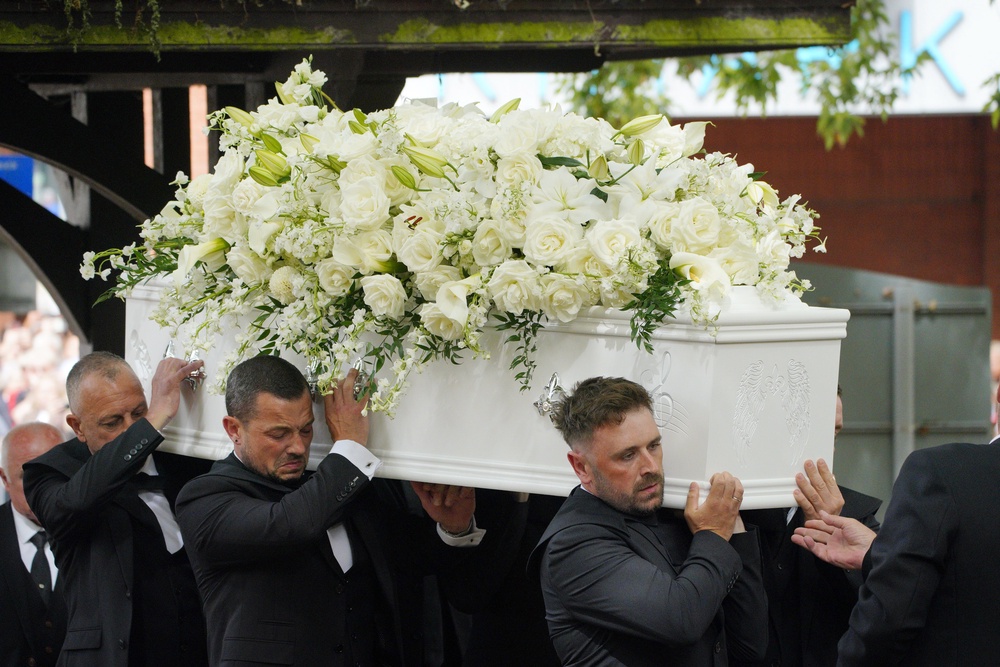 Fans applauded and shouted “goodbye” as the singer’s white coffin, etched with symbols including a microphone and a treble clef, was carried into Swansea Minster (Ben Birchall/PA) (PA Wire)
