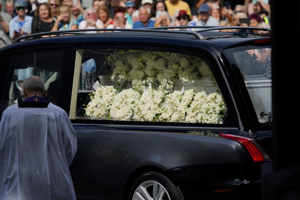 Floral tributes in the hearse carrying the coffin as it arrives for the funeral (Ben Birchall/PA) (PA Wire)