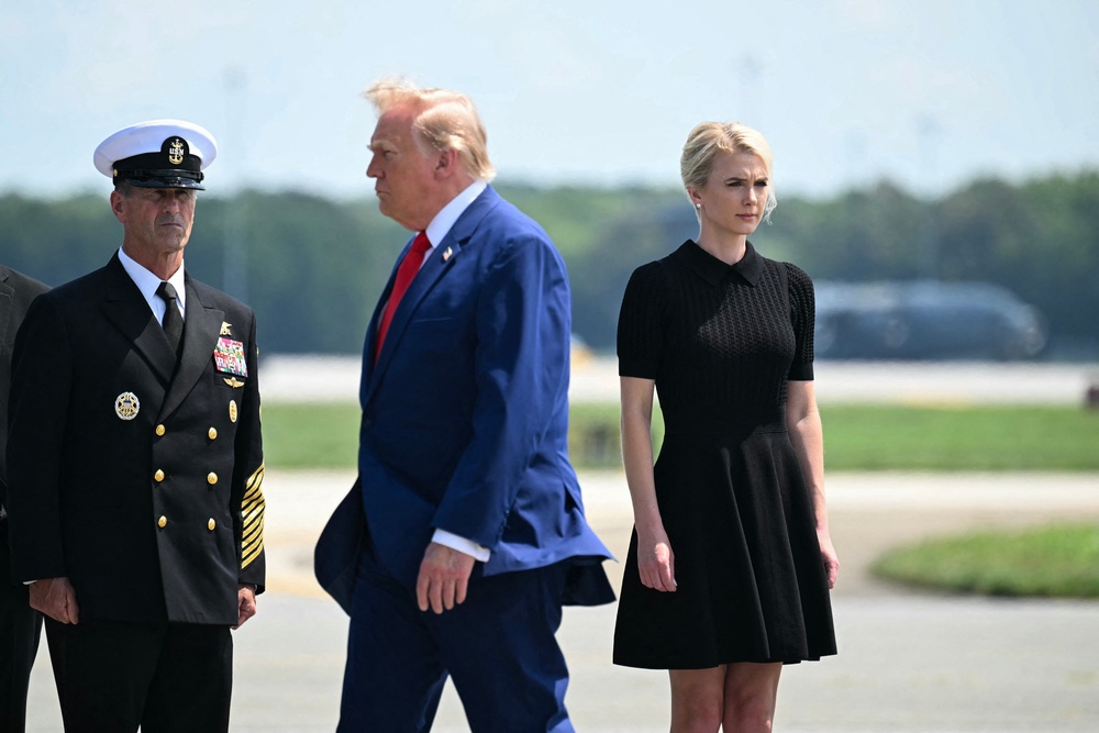 ‘Somebody needs to defend her honor,’ Jennings says of White House aide Natalie Harp, right, seen standing at attention as President Donald Trump walks past her (AFP/Getty)