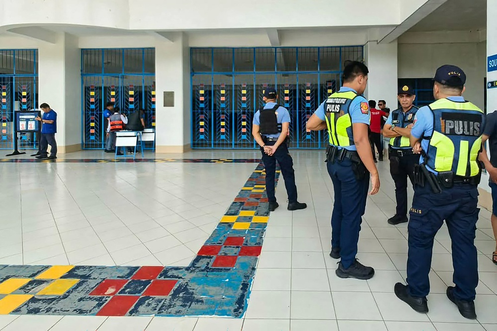 Philippine police gather at a school following a shooting in Zamboanga on 18 August 2026. A student was shot dead at a high school in the southern Philippines on August 18 before the alleged killer took his own life, police said (AFP/Getty)