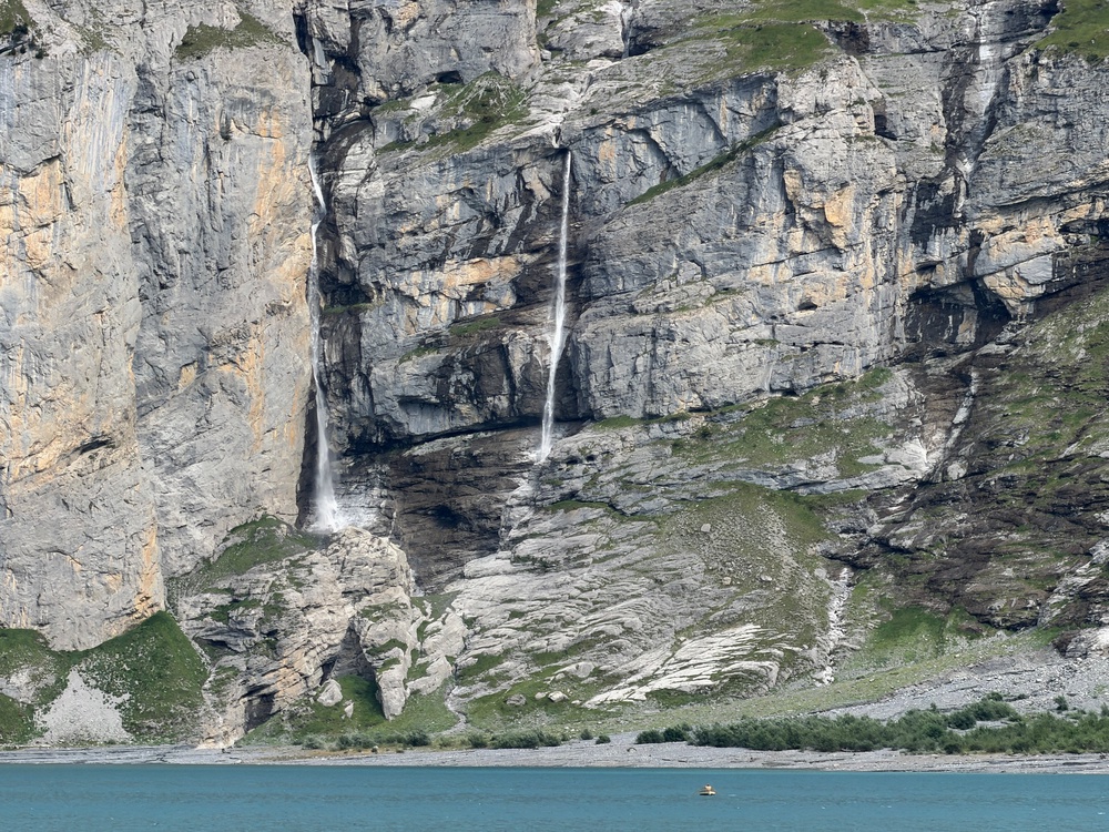 Streams of water from melting glaciers feeding Oeschinensee lake near Kandersteg, Switzerland, Tuesday, Aug. 4, 2026. (AP Photo/Hernan Munoz) (Copyright 2026 The Associated Press. All rights reserved)