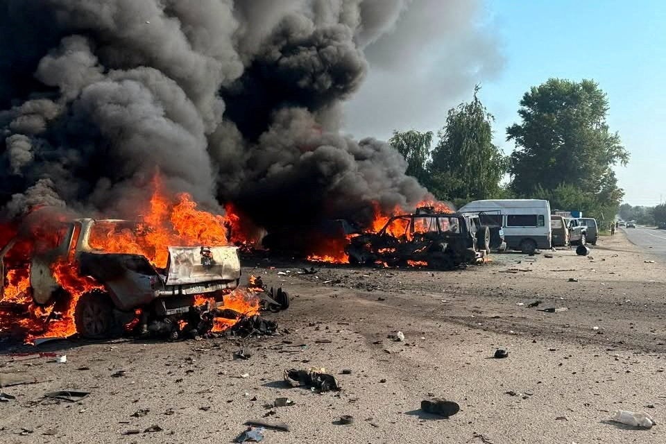 Vehicles burn after Russian drone strikes in the town of Pechenihy, during Russia's attack in Kharkiv on Tuesday (Reuters)