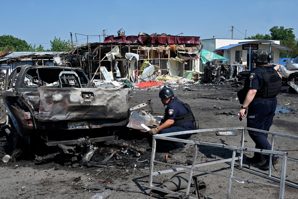 Ukrainian law enforcement officers continue to work at the site of the attack (AFP/Getty)