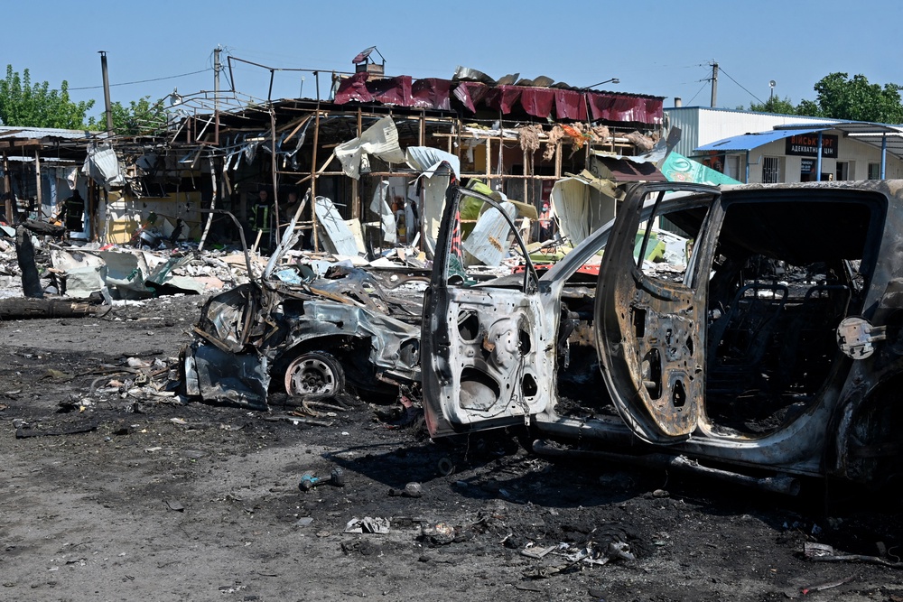 A heavily damaged vehicle and destroyed building at the site of Moscow's attack (AFP/Getty)