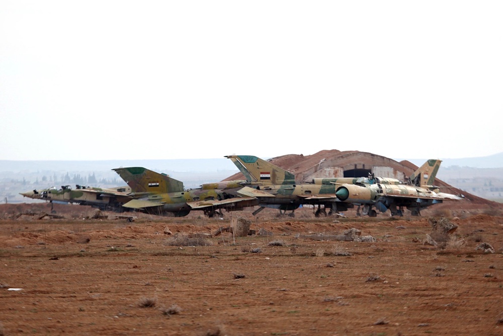 A picture taken on January 21, 2018 shows damaged Syrian air force fighter planes at the Abu Duhur military airport area in Syria's Idlib province. (AFP/Getty)