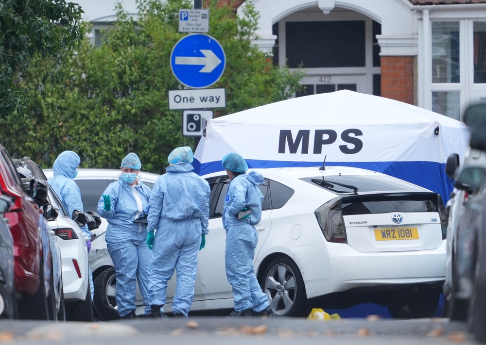 Forensic investigators at the scene on St Bartholomew's Road, Newham, east London, where Masum Miah was found inside a vehicle with gunshot wounds (PA)