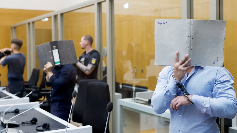 The Ukrainian defendants suspected to be acting on behalf of a Russian intelligence service covered their faces as they arrived in the courtroom (Reuters)