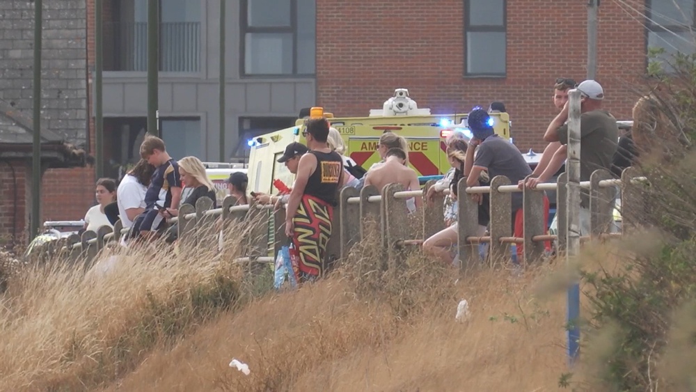 People watch after three people got into difficulty at Shoreham-by-Sea (PA)