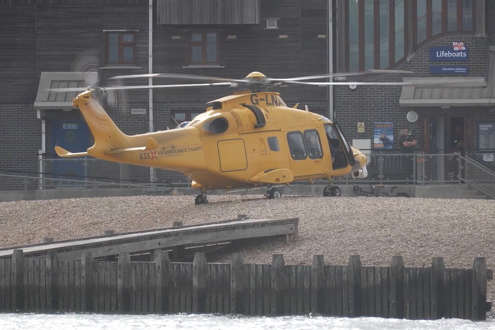 An air ambulance lands on the beach at Shoreham-by-Sea (PA)