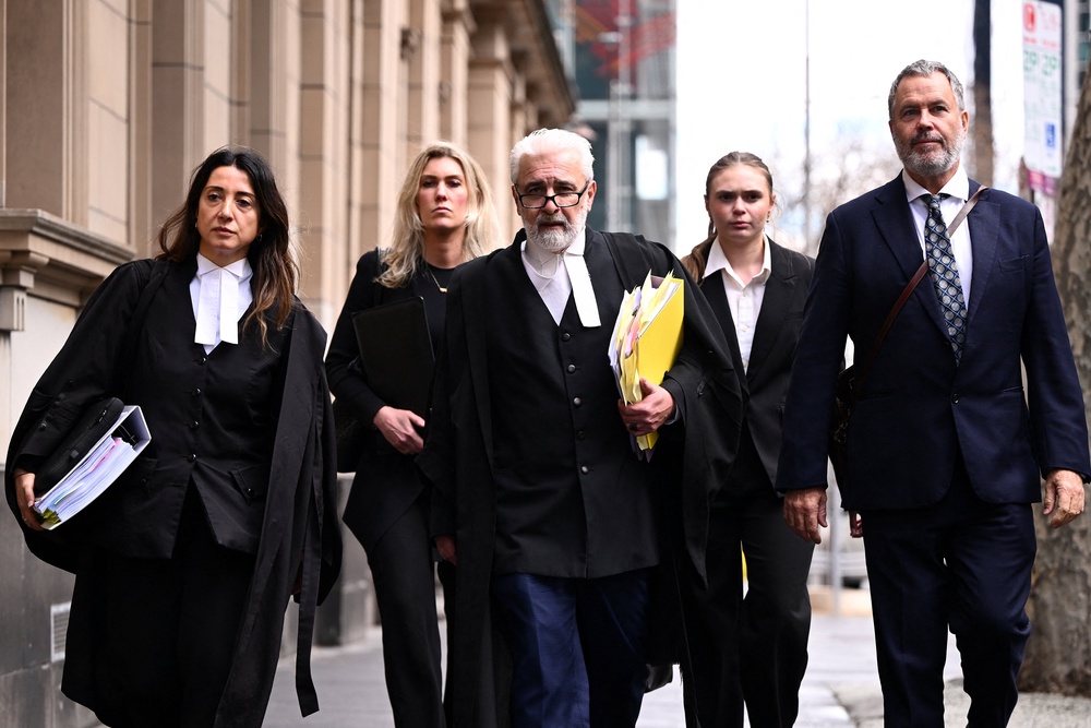 Erin Patterson’s barristers Veronika Drago and Richard Edney, and solicitor Bill Doogue, return to court during a break at the Supreme Court in Melbourne, Australia, on 19 August 2026 (Reuters)