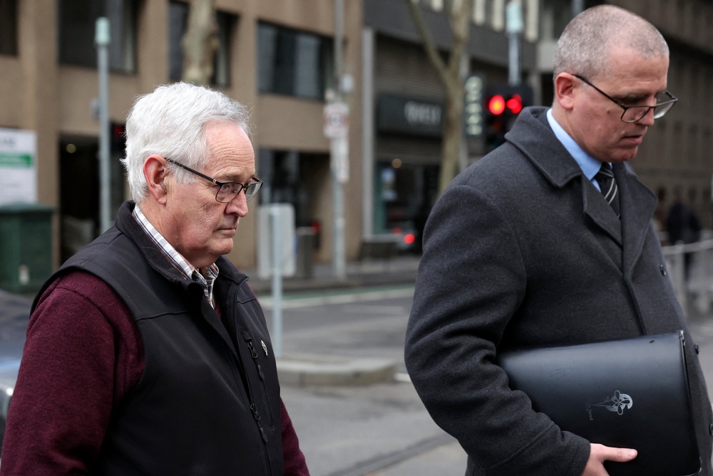 Ian Wilkinson, L, the only guest to survive the toxic mushroom lunch prepared by Erin Patterson, leave the Supreme Court of Victoria after the first day of the appeal hearing in Melbourne on 19 August 2026 (AFP/Getty)
