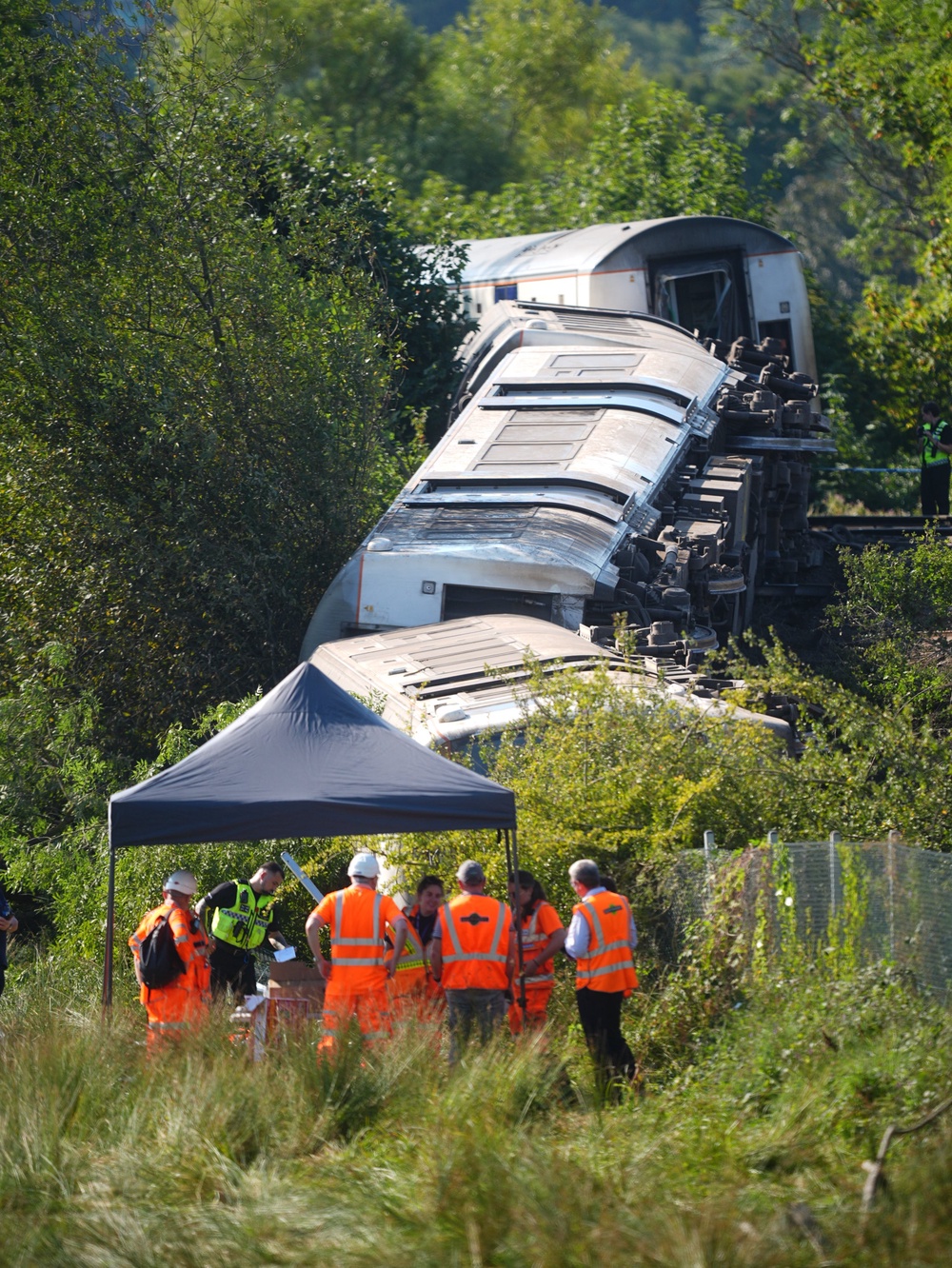 Rail staff at the scene in East Sussex where the train derailed (James Manning/PA) (PA Wire)