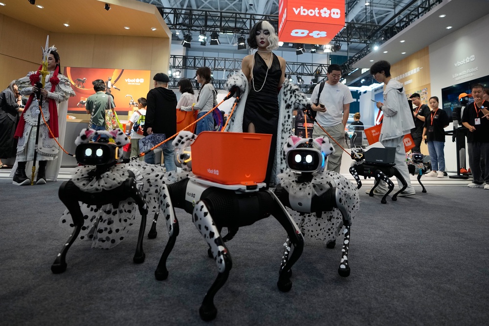 A model shows her fancy dressed up robotic dogs at a booth during the World Robot Conference at the Beiren Yichuang International Convention and Exhibition Centre in Beijing, Wednesday, Aug. 19, 2026 (AP)