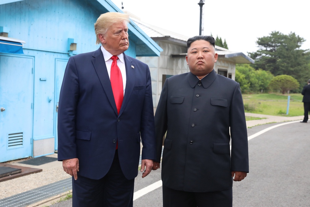 A handout photo provided by Dong-A Ilbo of North Korean leader Kim Jong Un and U.S. President Donald Trump inside the demilitarized zone (DMZ) separating the South and North Korea on 30 June 2019 in Panmunjom, South Korea (Getty)
