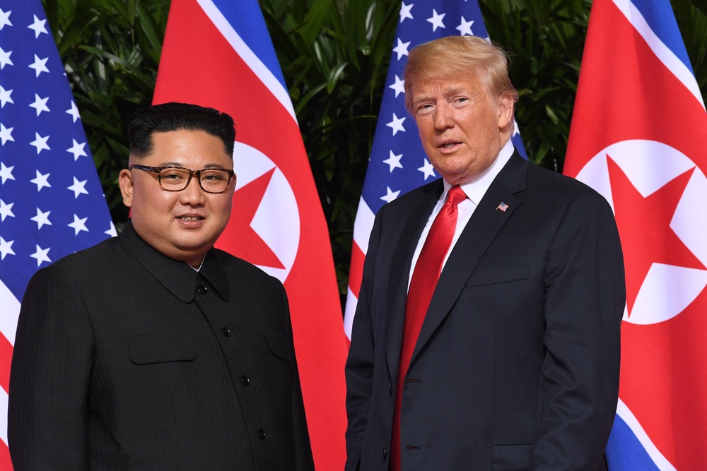 North Korean leader Kim Jong Un and US president Donald Trump at the start of their summit in Singapore on 12 June 2018 (AFP/Getty)