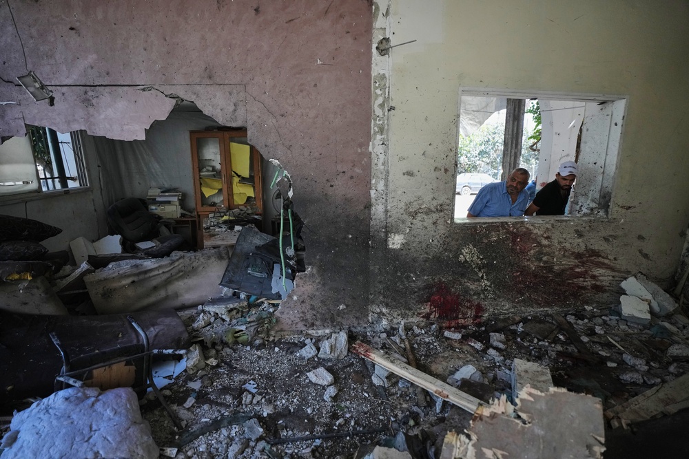 Palestinians inspect the damage after Wednesday's strikes in Gaza City (AP)