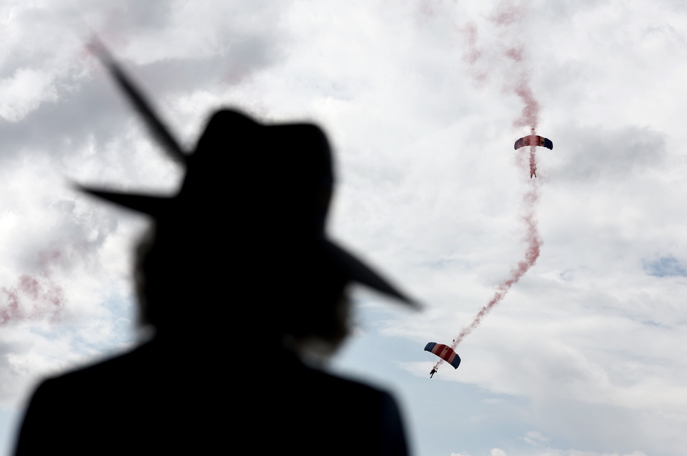 Camilla watches as the RAF Falcons Parachute Display Team drop onto the course (Chris Jackson/PA) (PA Wire)