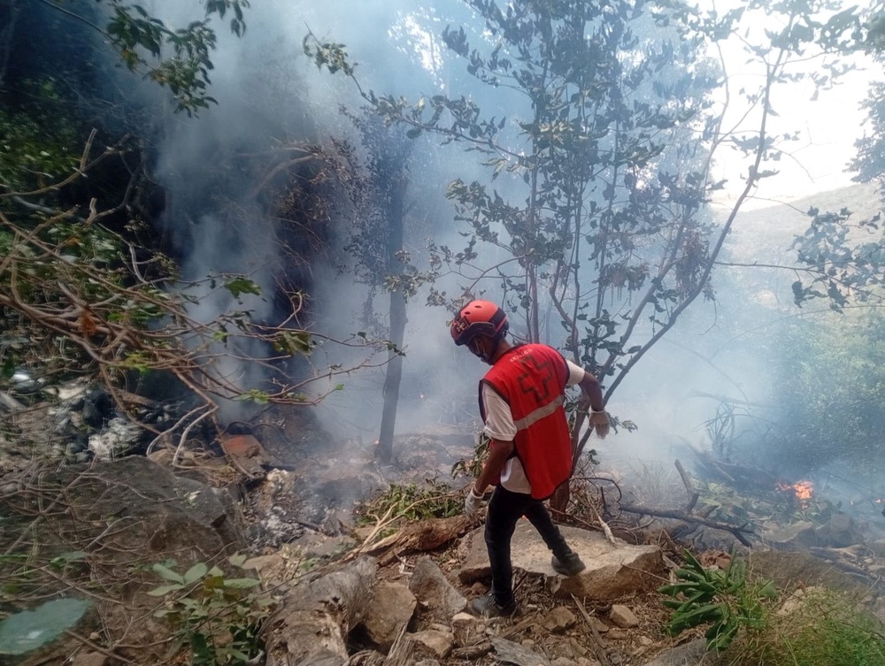 A rescue official works at the site of the crash that caused multiple casualties, according to the police, in Samburu County, Kenya (Kenya Red Cross)