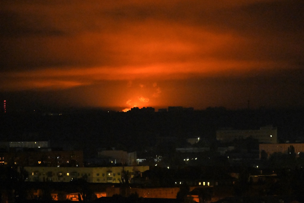 Explosion seen in distance in Kyiv after Russia launches ballistic missiles on Ukrainian capital (AFP/Getty)
