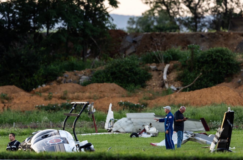 Authorities investigate a crash involving a Pennsylvania State Police helicopter and a small plane at the Carlisle airport (AP)